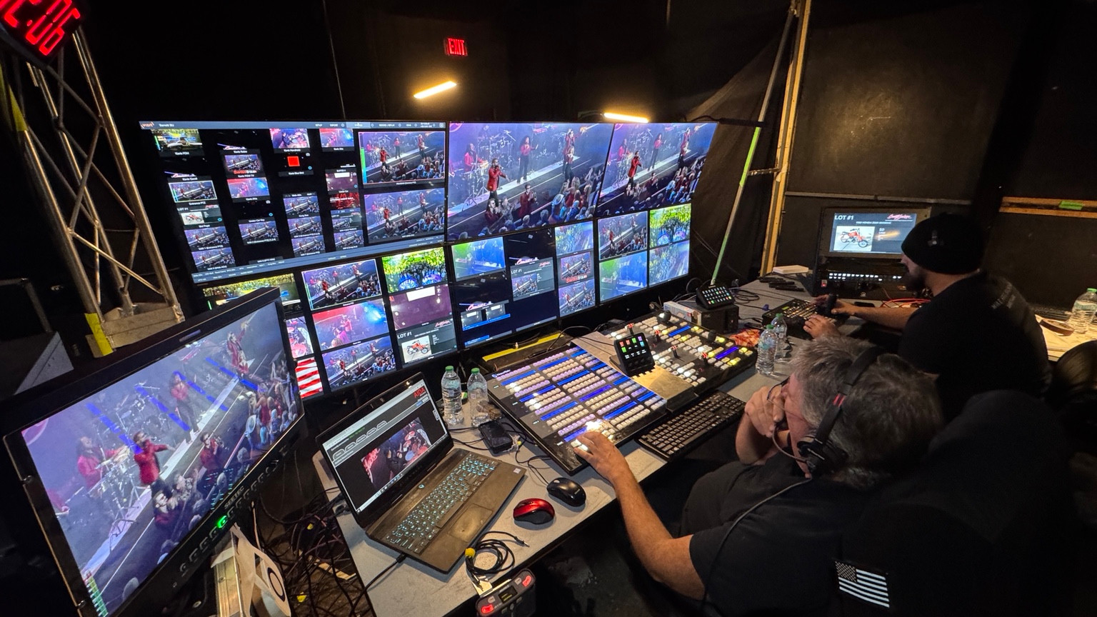 Operators in a live-production control room with video multiviews and Barrett-Jackson feeds